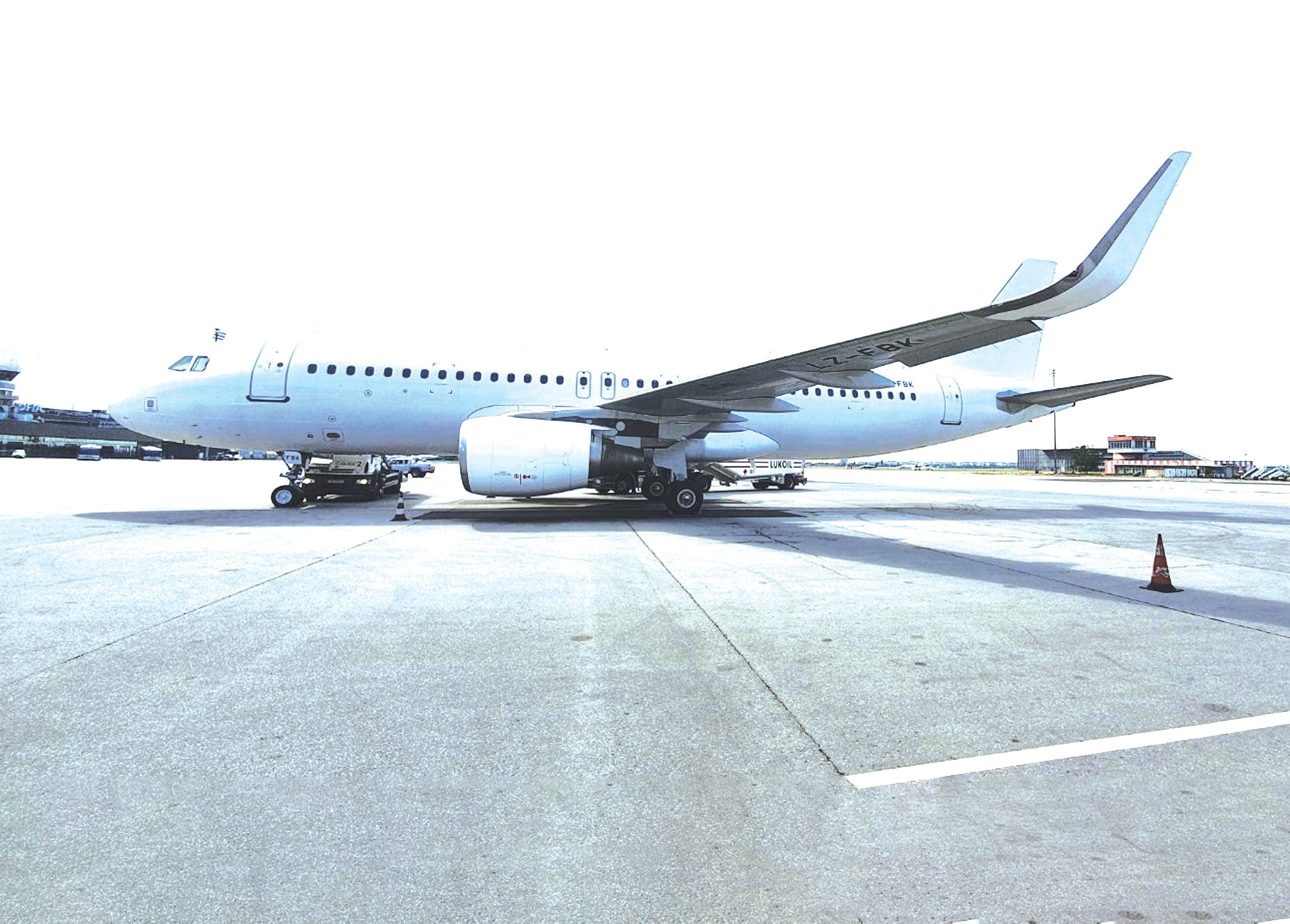 Airbus A320-family airliner in plain white livery on the apron